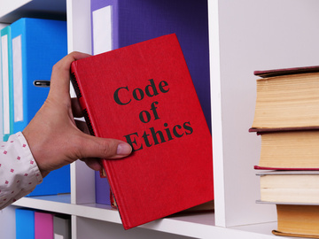 Code of Ethics Red Book on bookshelf