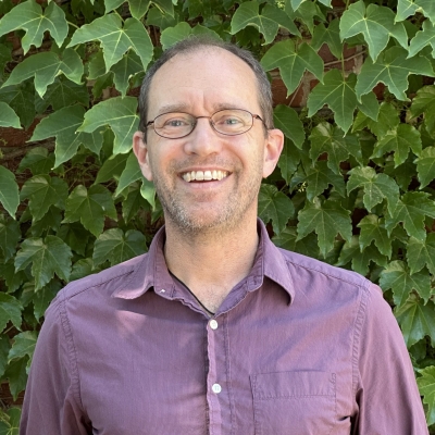 Mark Kinsey in purple shirt headshot