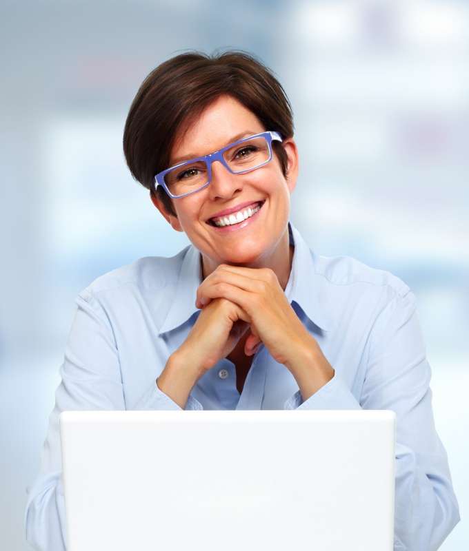 Supportive smiling female with laptop